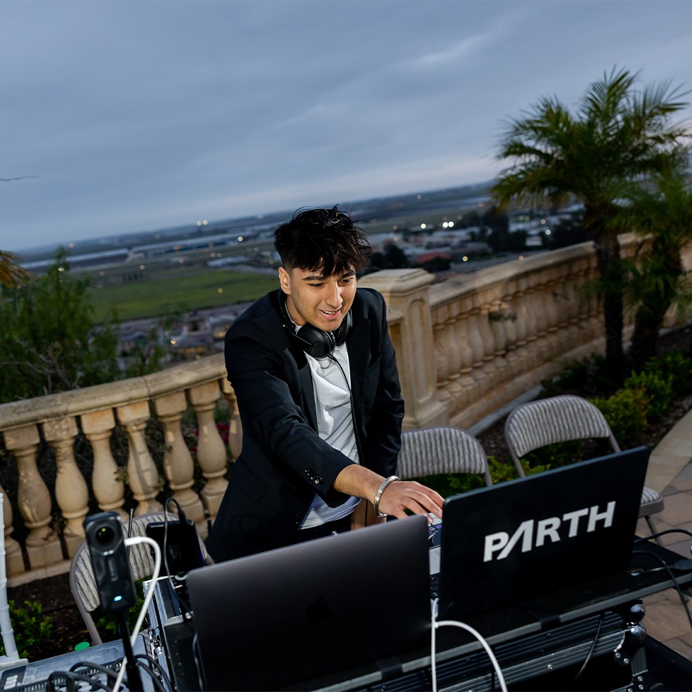 DJ at the booth under deep violet stage lighting
